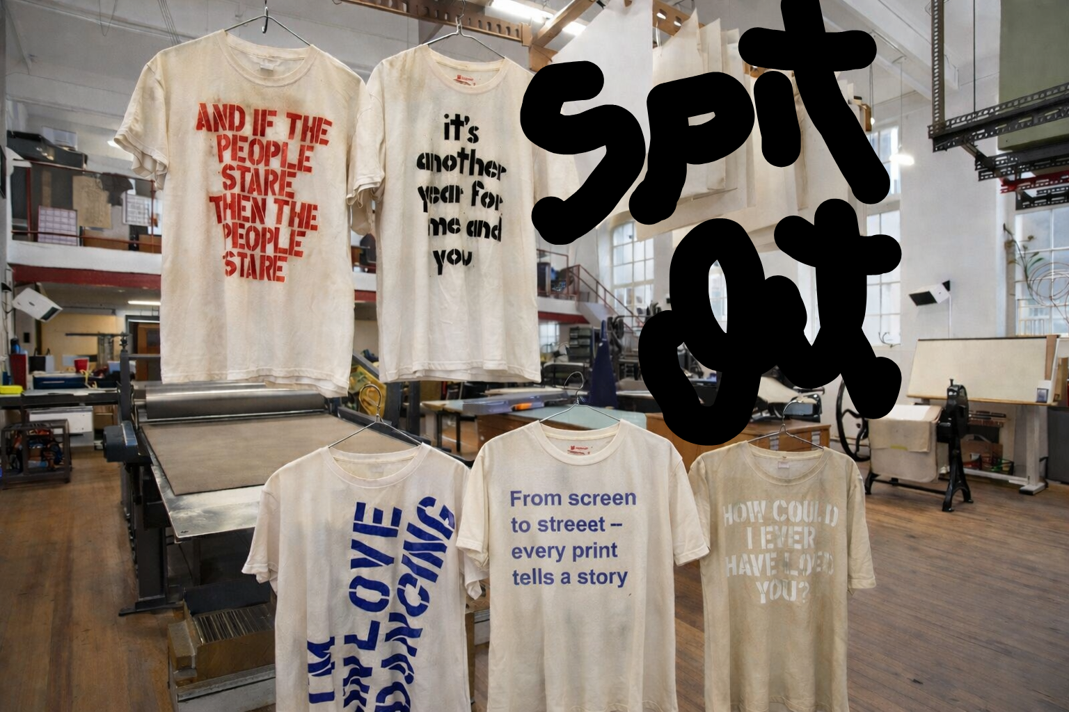 T-shirts with various prints hanging in a printing studio.